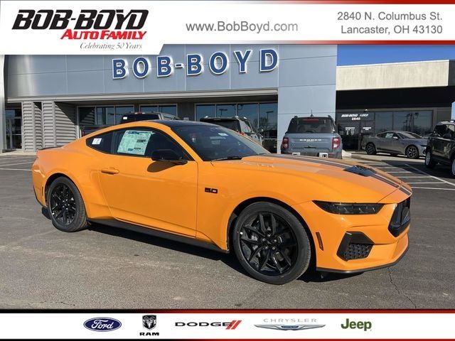 2026 Ford Mustang GT Premium in Orange Fury Metallic Tri-Coat — front three-quarter view